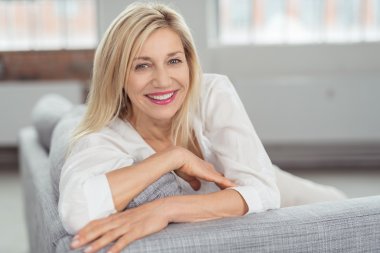 depositphotos_74221797-stock-photo-happy-adult-woman-on-couch